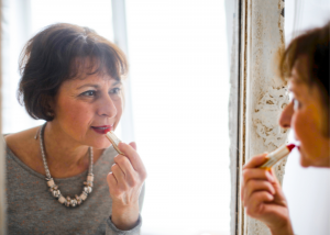 Woman applying lipstick