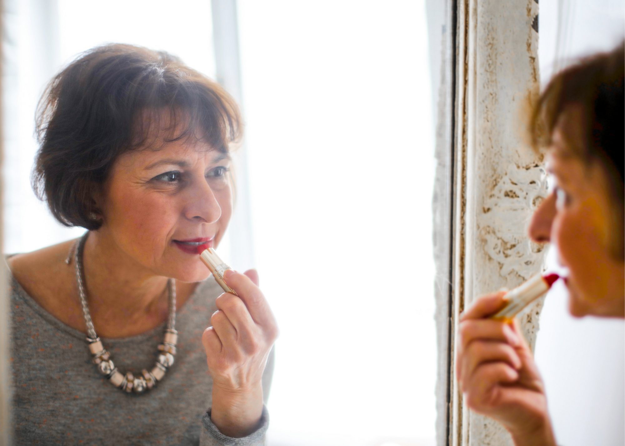 Woman applying lipstick